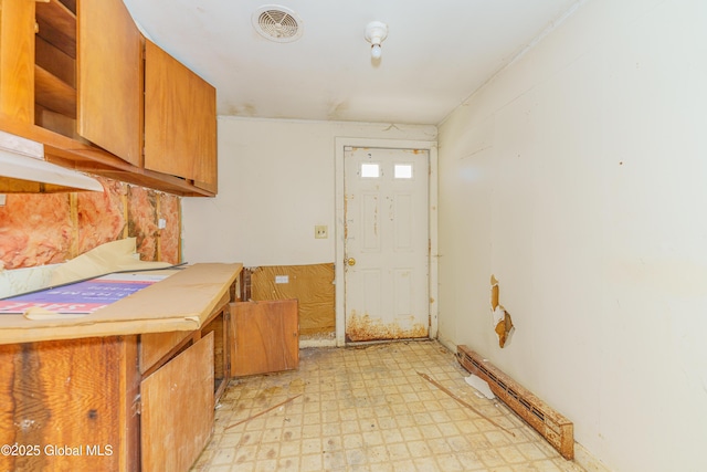 3885 Main St, Warrensburg, NY 12885 - kitchen with light floors, brown cabinets, and open shelves