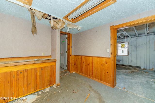 3885 Main St, Warrensburg, NY 12885 - below grade area featuring a textured ceiling and wood walls