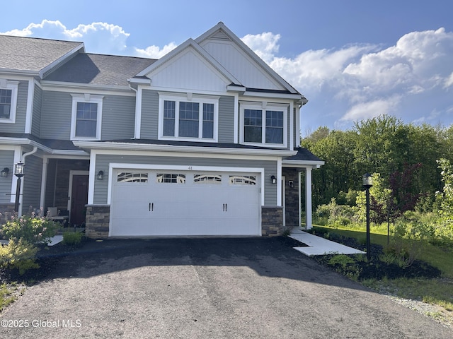 41 Hillard Ln, Colonie, NY 12110 - craftsman-style home with a garage, stone siding, driveway, and board and batten siding