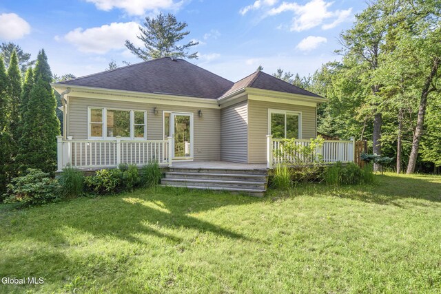 108 La Flamme Rd, Providence, NY 12850 - rear view of house featuring a shingled roof, a lawn, and a wooden deck