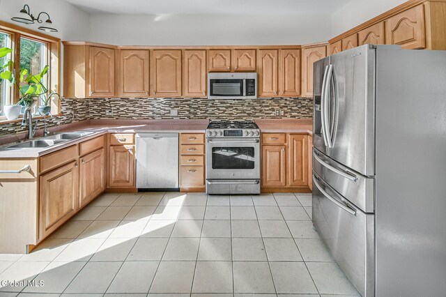 108 La Flamme Rd, Providence, NY 12850 - kitchen featuring appliances with stainless steel finishes, backsplash, light countertops, and light tile patterned floors