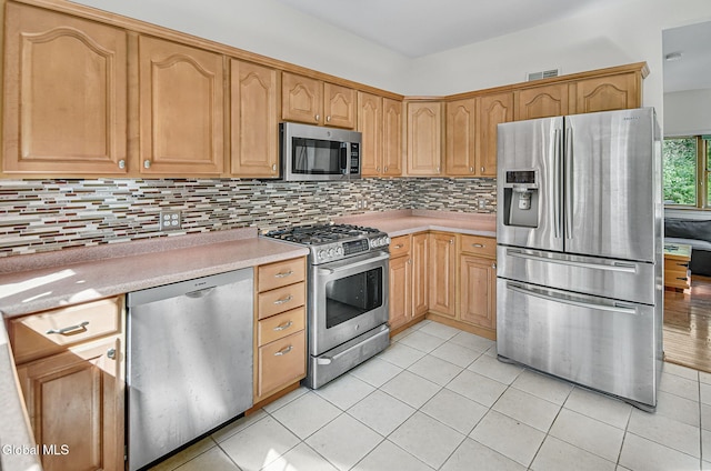 108 La Flamme Rd, Providence, NY 12850 - kitchen with appliances with stainless steel finishes, light countertops, tasteful backsplash, and light tile patterned flooring