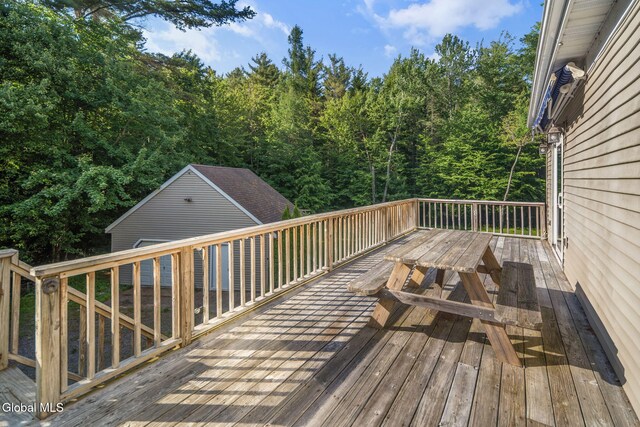 108 La Flamme Rd, Providence, NY 12850 - wooden terrace with outdoor dining area and a wooded view