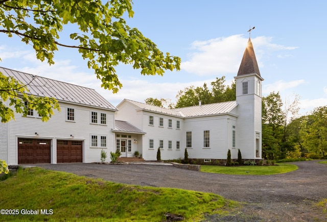 1174 Potter Mountain Rd, Gilboa, NY 12076 - view of front of house featuring a garage, driveway, a standing seam roof, a front lawn, and a metal roof