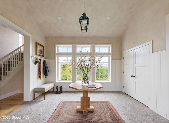 1174 Potter Mountain Rd, Gilboa, NY 12076 - foyer with stairs, a chandelier, a wainscoted wall, and vaulted ceiling