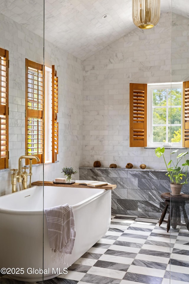 1174 Potter Mountain Rd, Gilboa, NY 12076 - bathroom featuring healthy amount of natural light, tile patterned floors, a soaking tub, and lofted ceiling