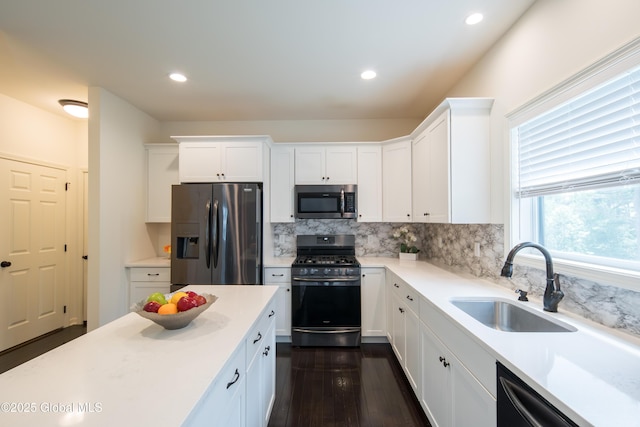 24 Utica Ave, Colonie, NY 12110 - kitchen featuring stainless steel appliances, white cabinetry, backsplash, light countertops, and dark wood-style floors