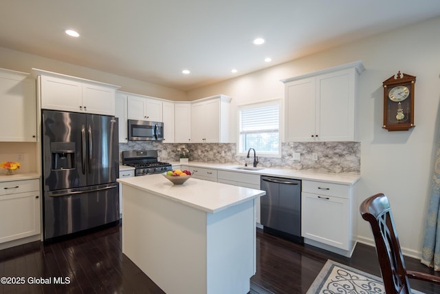 24 Utica Ave, Colonie, NY 12110 - kitchen featuring appliances with stainless steel finishes, dark wood finished floors, decorative backsplash, white cabinetry, and recessed lighting