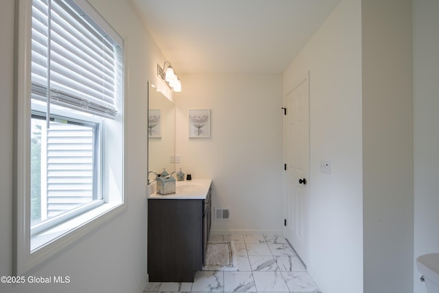 24 Utica Ave, Colonie, NY 12110 - bathroom featuring plenty of natural light, marble look tiles, and vanity