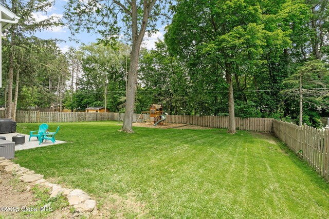 12 Glen Ter, Glenville, NY 12302 - fenced backyard with a playground, a patio, and view of scattered trees