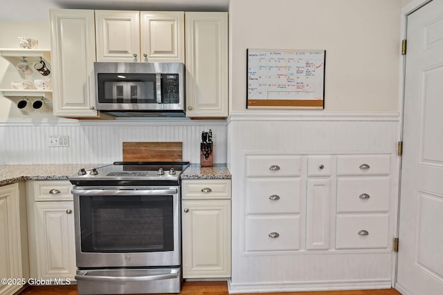 12 Glen Ter, Glenville, NY 12302 - kitchen with stainless steel appliances, wainscoting, light stone counters, white cabinetry, and open shelves