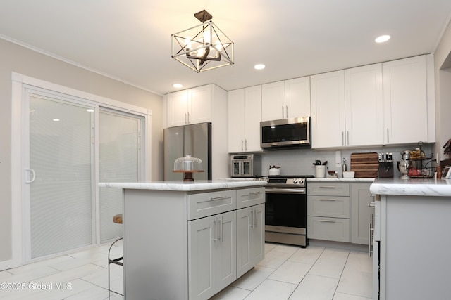143 Maple Ave, Middleburgh, NY 12122 - kitchen with stainless steel appliances, tasteful backsplash, ornamental molding, a center island, and white cabinetry