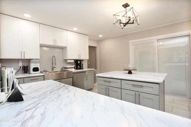 143 Maple Ave, Middleburgh, NY 12122 - kitchen with gray cabinets, tasteful backsplash, light stone counters, decorative light fixtures, and white cabinetry