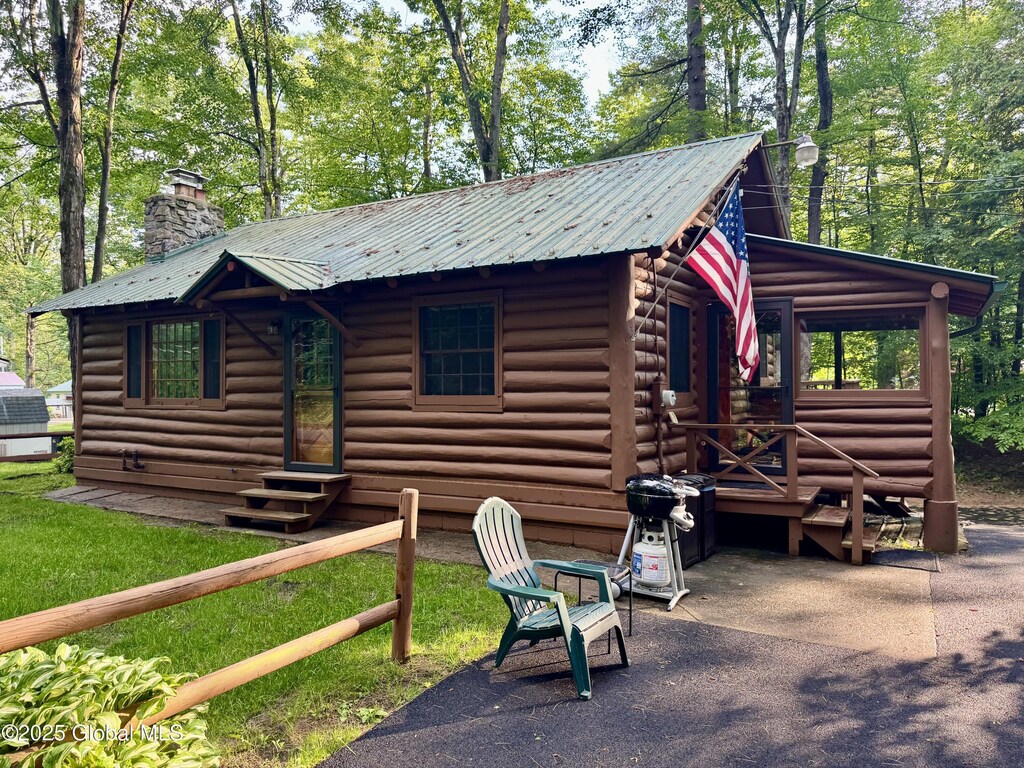 15 Corinth Pl, Hadley, NY 12835 - view of front of home with entry steps, a chimney, and a metal roof