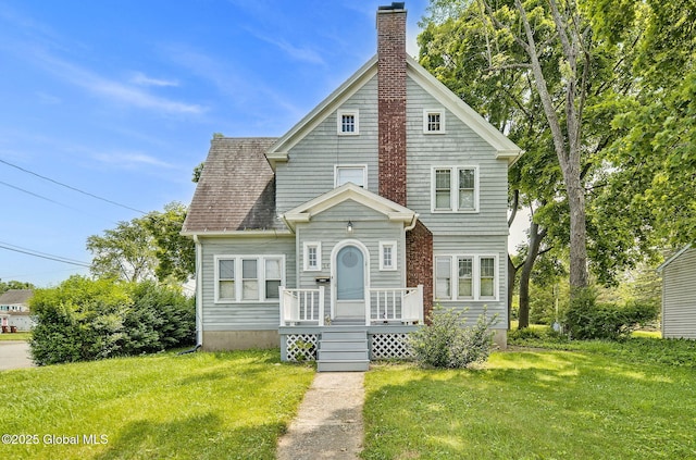 54 Wendell St, Ravena, NY 12143 - view of front of home featuring a chimney and a front lawn