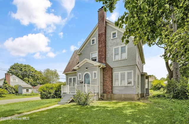 54 Wendell St, Ravena, NY 12143 - view of front of house with a chimney, a front yard, and a deck