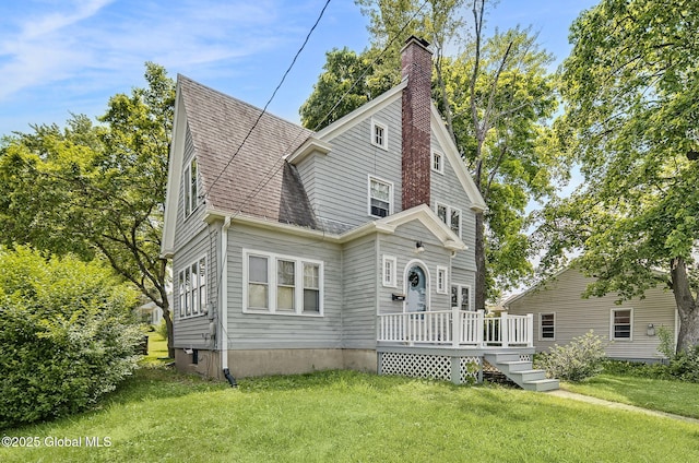 54 Wendell St, Ravena, NY 12143 - view of front of house featuring a deck, a front lawn, a chimney, and roof with shingles