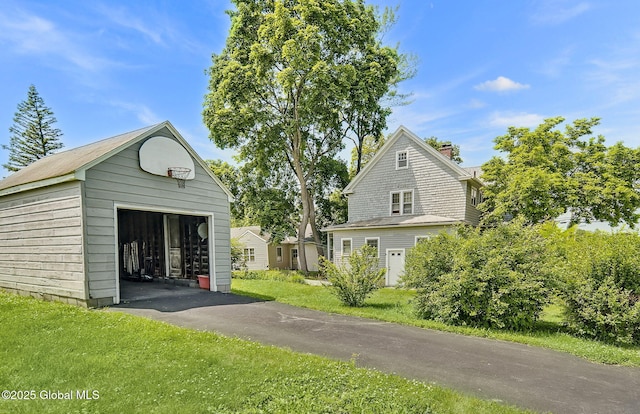 54 Wendell St, Ravena, NY 12143 - view of home's exterior with a detached garage, an outdoor structure, and a lawn