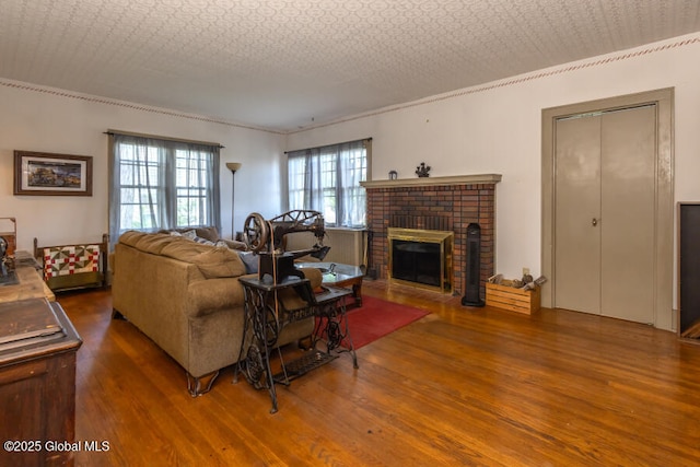 54 Wendell St, Ravena, NY 12143 - living area with wood finished floors, crown molding, and a fireplace