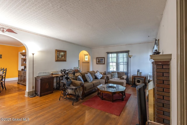 54 Wendell St, Ravena, NY 12143 - living room featuring arched walkways, light wood-style floors, and ornamental molding