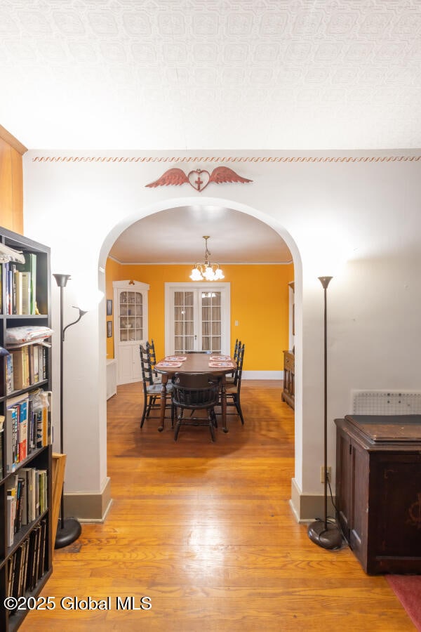 54 Wendell St, Ravena, NY 12143 - dining space with arched walkways, light wood-style flooring, and a chandelier