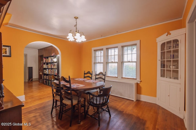 54 Wendell St, Ravena, NY 12143 - dining room featuring radiator, arched walkways, wood finished floors, ornamental molding, and a chandelier