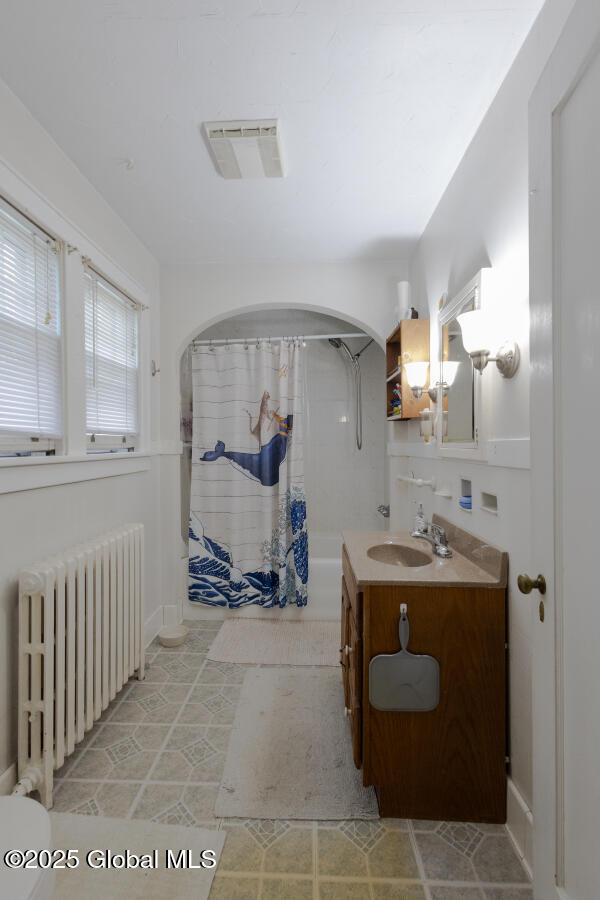 54 Wendell St, Ravena, NY 12143 - full bath with radiator, vanity, and shower / bathtub combination with curtain