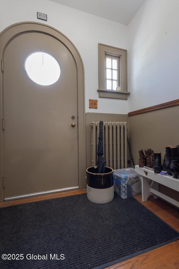 54 Wendell St, Ravena, NY 12143 - entrance foyer featuring radiator heating unit and wood finished floors