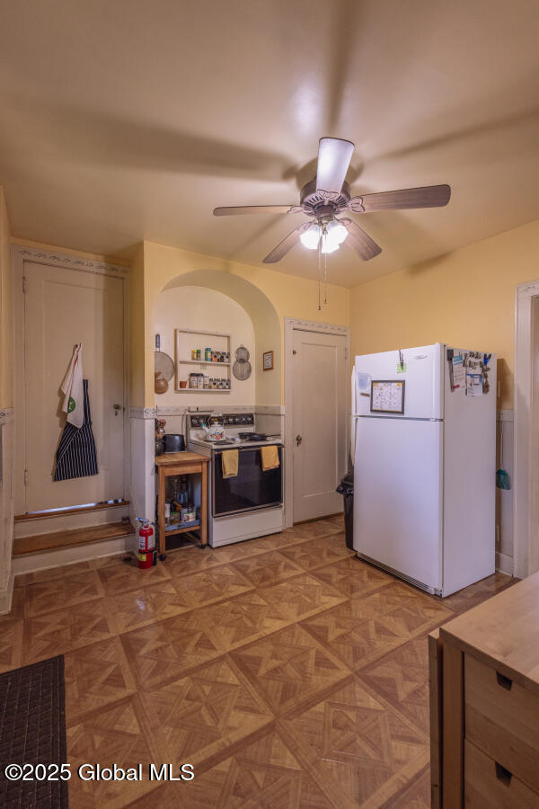 54 Wendell St, Ravena, NY 12143 - kitchen featuring white appliances, a ceiling fan, and arched walkways