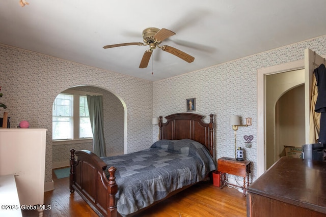 54 Wendell St, Ravena, NY 12143 - bedroom with wood finished floors, arched walkways, wallpapered walls, and ceiling fan