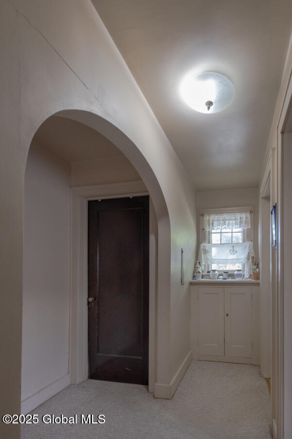 54 Wendell St, Ravena, NY 12143 - corridor with light colored carpet and arched walkways