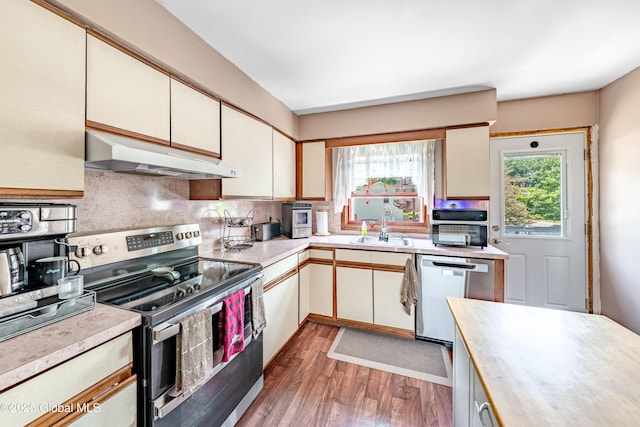 2 Moonglow Rd, Wilton, NY 12831 - kitchen with stainless steel appliances, under cabinet range hood, light countertops, tasteful backsplash, and wood finished floors