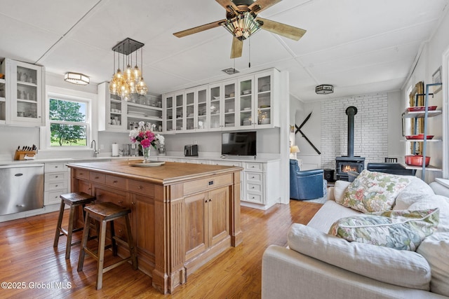 378 County Route 354, Rensselaerville, NY 12469 - kitchen with open floor plan, dishwasher, a wood stove, and light wood-style flooring