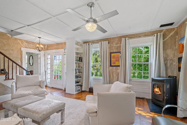 378 County Route 354, Rensselaerville, NY 12469 - living area with a wood stove, wood finished floors, plenty of natural light, and stairway