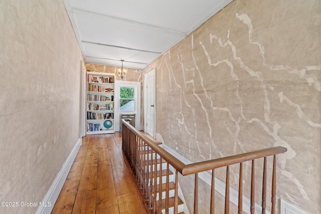 378 County Route 354, Rensselaerville, NY 12469 - hall with a chandelier, hardwood / wood-style flooring, built in features, and an upstairs landing