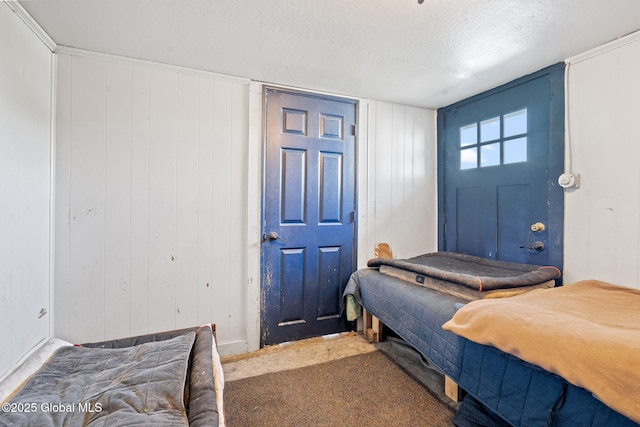 378 County Route 354, Rensselaerville, NY 12469 - bedroom featuring carpet flooring, a textured ceiling, and wood walls