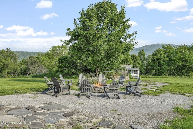 378 County Route 354, Rensselaerville, NY 12469 - view of patio with a fire pit, a mountain view, and a wooded view