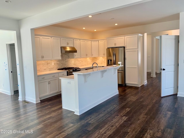 LOT17 Windrow Way, Halfmoon, NY 12118 - kitchen with under cabinet range hood, gas range oven, stainless steel fridge with ice dispenser, light countertops, and white cabinetry