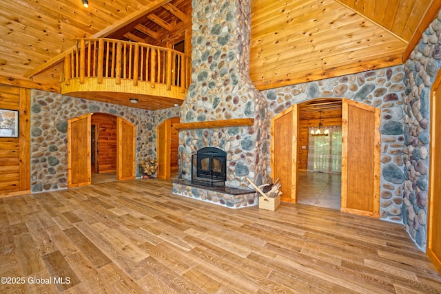 236 Colfax Rd, Jackson, NY 12816 - unfurnished living room featuring arched walkways, high vaulted ceiling, a wooden ceiling with exposed beams, wood finished floors, and a chandelier