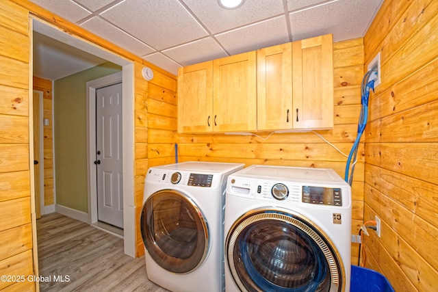 236 Colfax Rd, Jackson, NY 12816 - washroom featuring cabinet space, washing machine and dryer, light wood finished floors, and wood walls