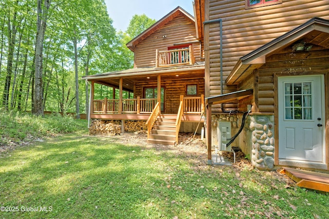 236 Colfax Rd, Jackson, NY 12816 - rear view of house featuring faux log siding, a lawn, and a wooden deck