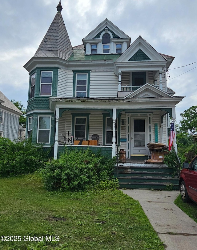 8 Main St, Hudson Falls, NY 12839 - victorian home featuring covered porch, a front yard, and a balcony