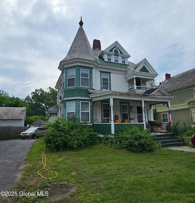 8 Main St, Hudson Falls, NY 12839 - victorian-style house with a porch, a front yard, and a chimney