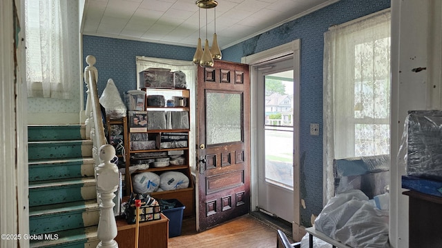 8 Main St, Hudson Falls, NY 12839 - entryway featuring wallpapered walls, ornamental molding, wood finished floors, and stairway