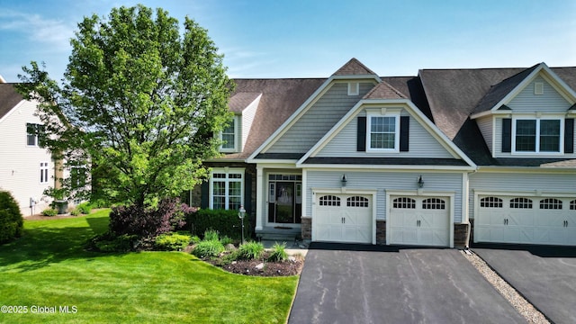 20 Beekman Pl, Queensbury, NY 12804 - view of front facade with asphalt driveway, a front lawn, roof with shingles, stone siding, and an attached garage