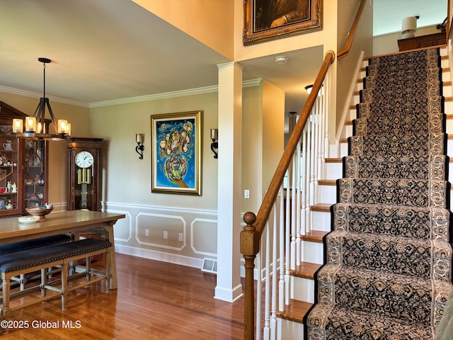 20 Beekman Pl, Queensbury, NY 12804 - stairs with a chandelier, wood finished floors, and crown molding