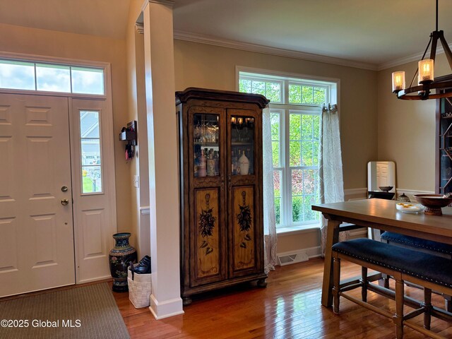 20 Beekman Pl, Queensbury, NY 12804 - foyer entrance with hardwood / wood-style floors, healthy amount of natural light, ornamental molding, and a chandelier