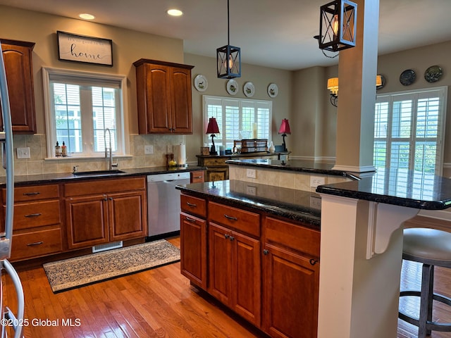 20 Beekman Pl, Queensbury, NY 12804 - kitchen featuring stainless steel dishwasher, a breakfast bar, healthy amount of natural light, decorative backsplash, and recessed lighting