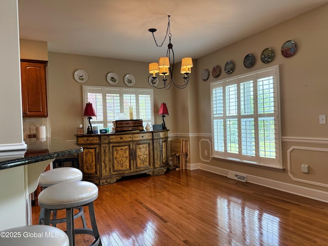 20 Beekman Pl, Queensbury, NY 12804 - dining room with hardwood / wood-style flooring and a chandelier