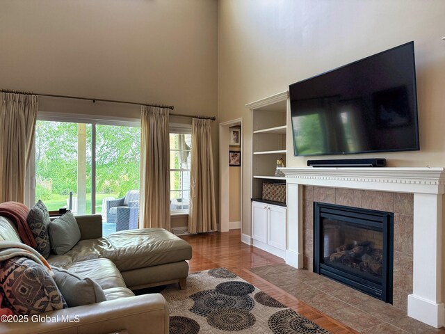 20 Beekman Pl, Queensbury, NY 12804 - living area with wood finished floors, a high ceiling, and a fireplace